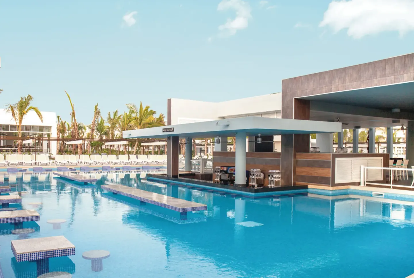 Aquamar swim-up bar and pool with lounge chairs at Hotel Riu Republica.