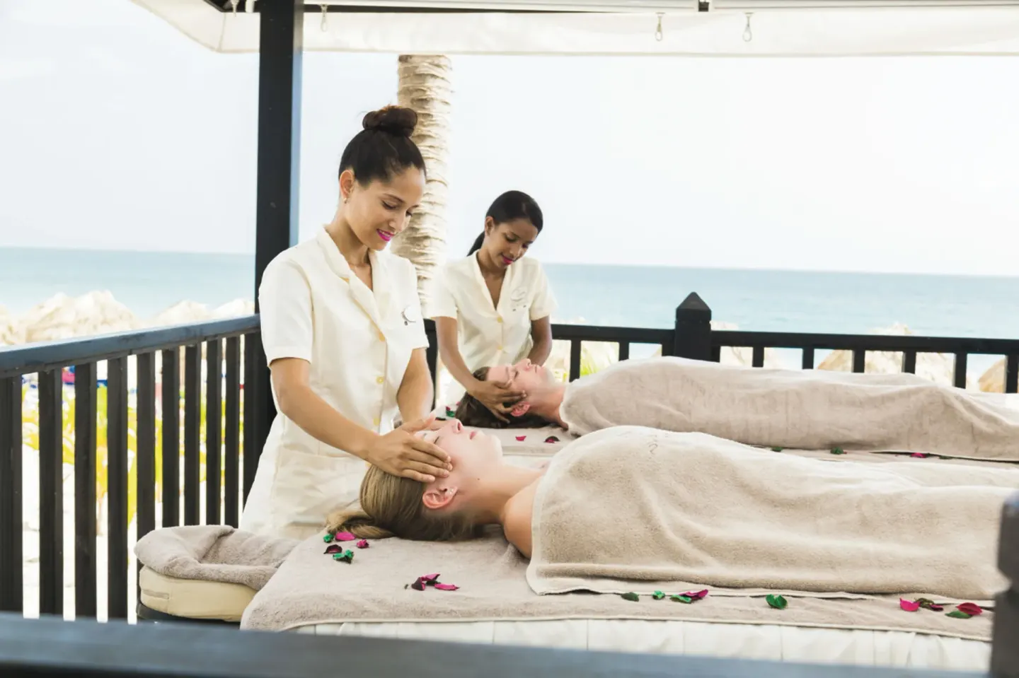 Open-air spa massage with ocean view and two guests at Hotel Riu Republica.