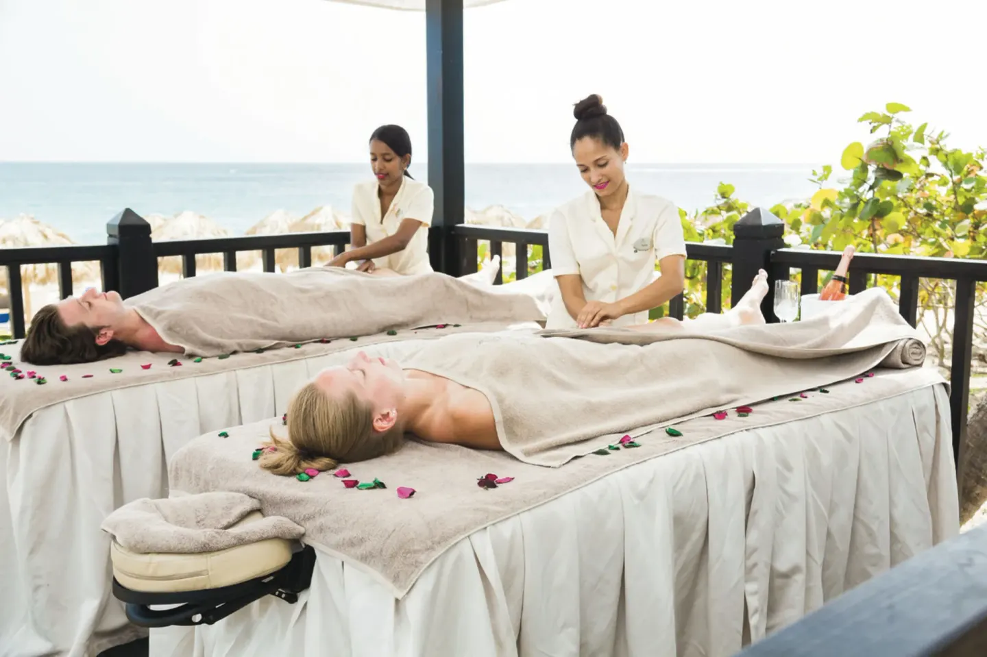 Outdoor seaside spa massage tables with two guests at Hotel Riu Republica.