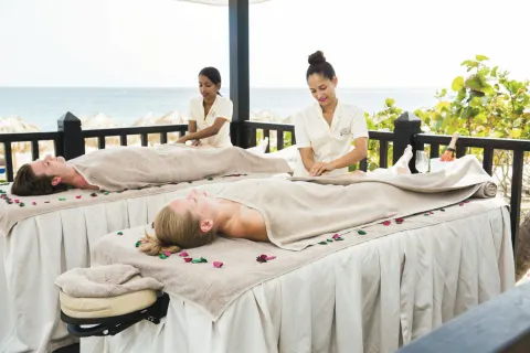 Outdoor seaside spa massage tables with two guests at Hotel Riu Republica.