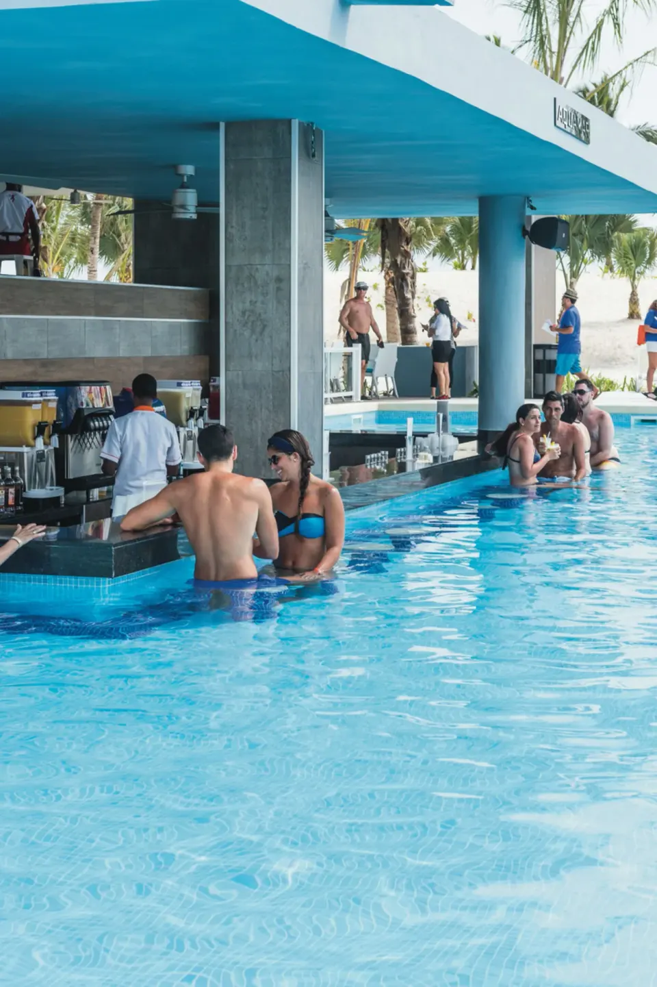 Guests at the Aquamar swim-up bar in the pool at Hotel Riu Republica.