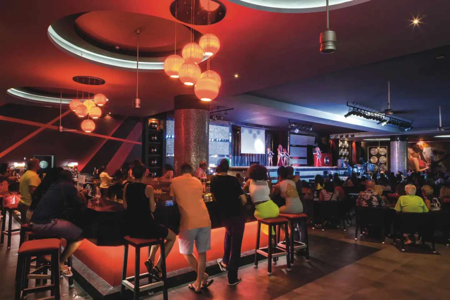 Guests watch a stage show from a bar lounge at Hotel Riu Republica.