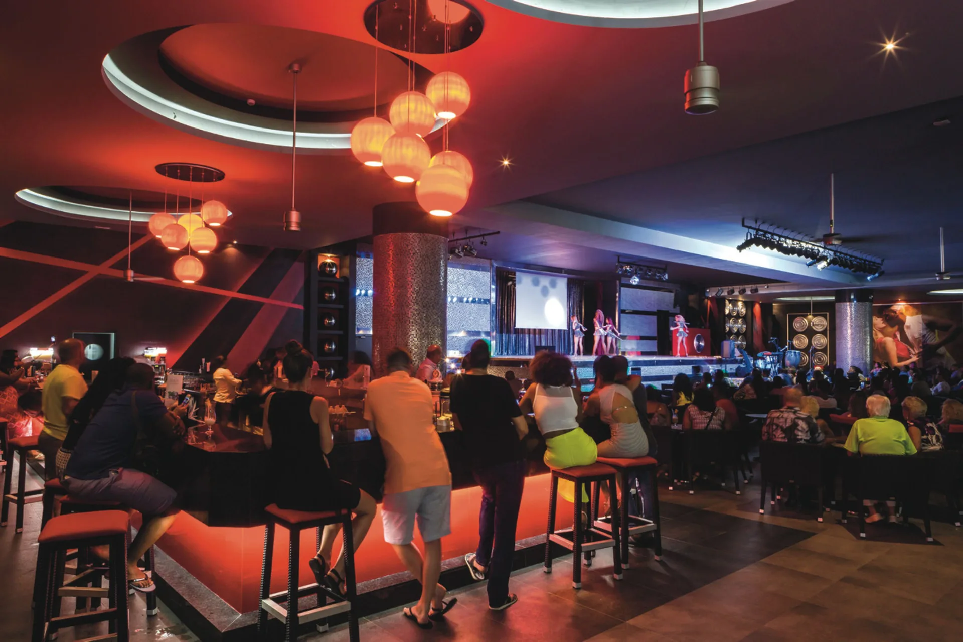 Guests watch a stage show from a bar lounge at Hotel Riu Republica.