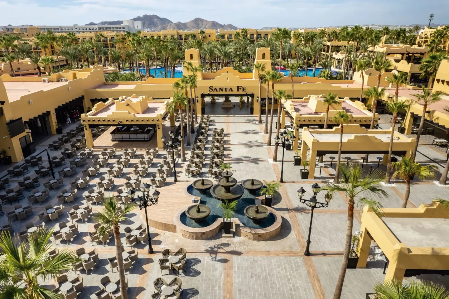 An aerial view shows the central plaza and fountains at Hotel Riu Santa Fe.