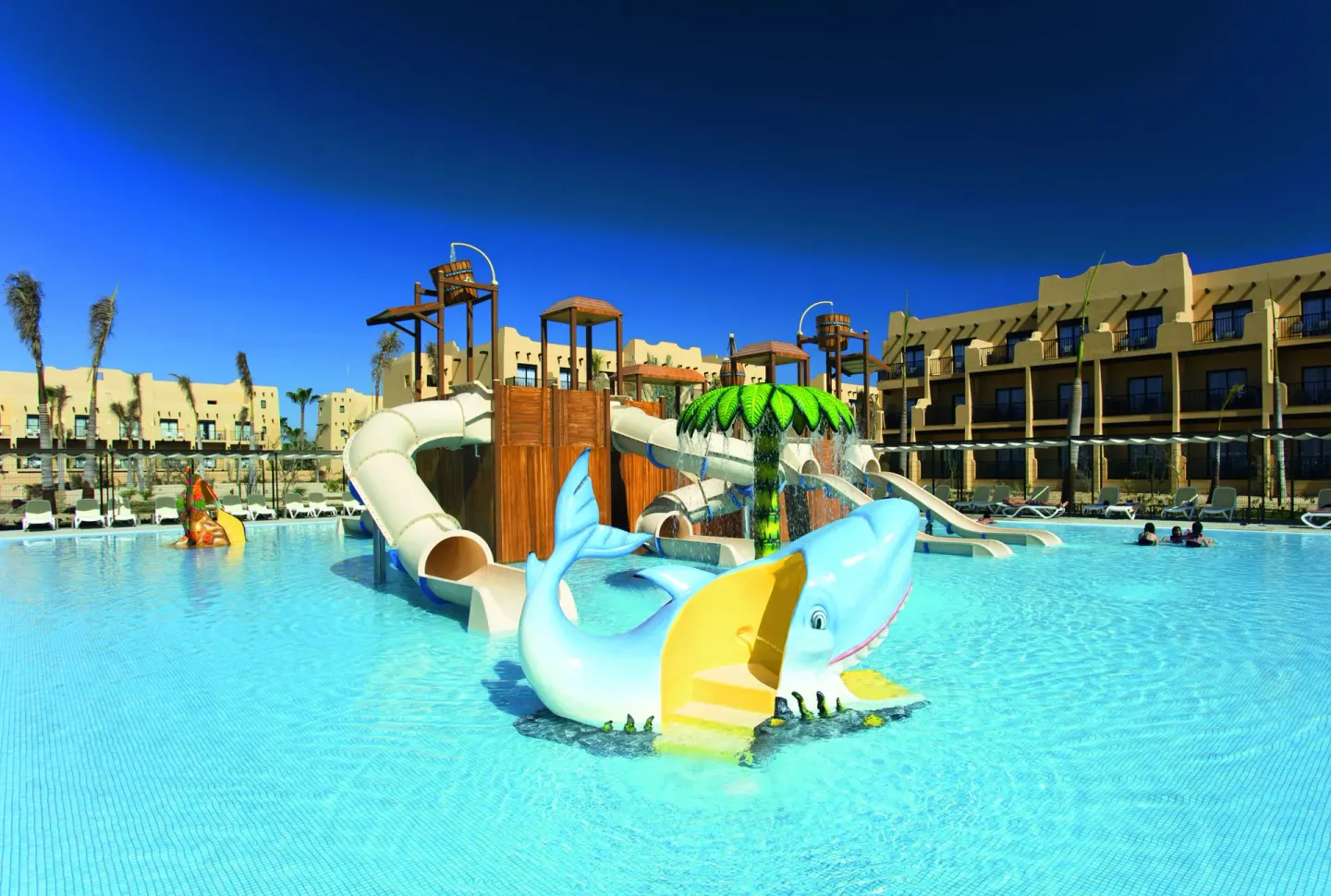 Children's pool with slides and a dolphin play feature at Hotel Riu Santa Fe.