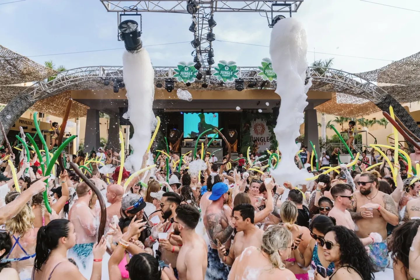 Foam party crowd dancing by the pool stage at Hotel Riu Santa Fe.
