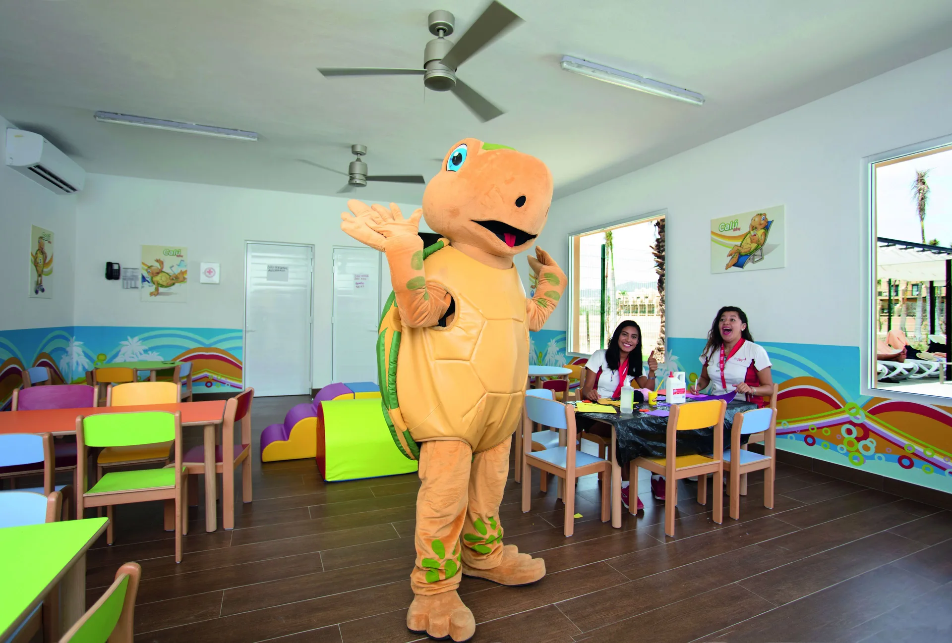 Turtle mascot greeting children in the kids club at Hotel Riu Santa Fe.