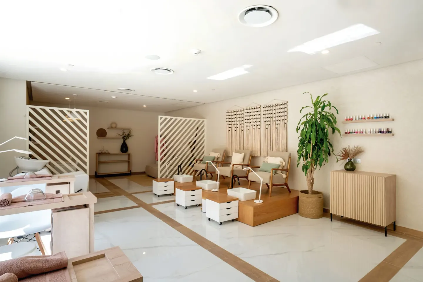 A spa salon with pedicure chairs and manicure stations at Hotel Riu Santa Fe.