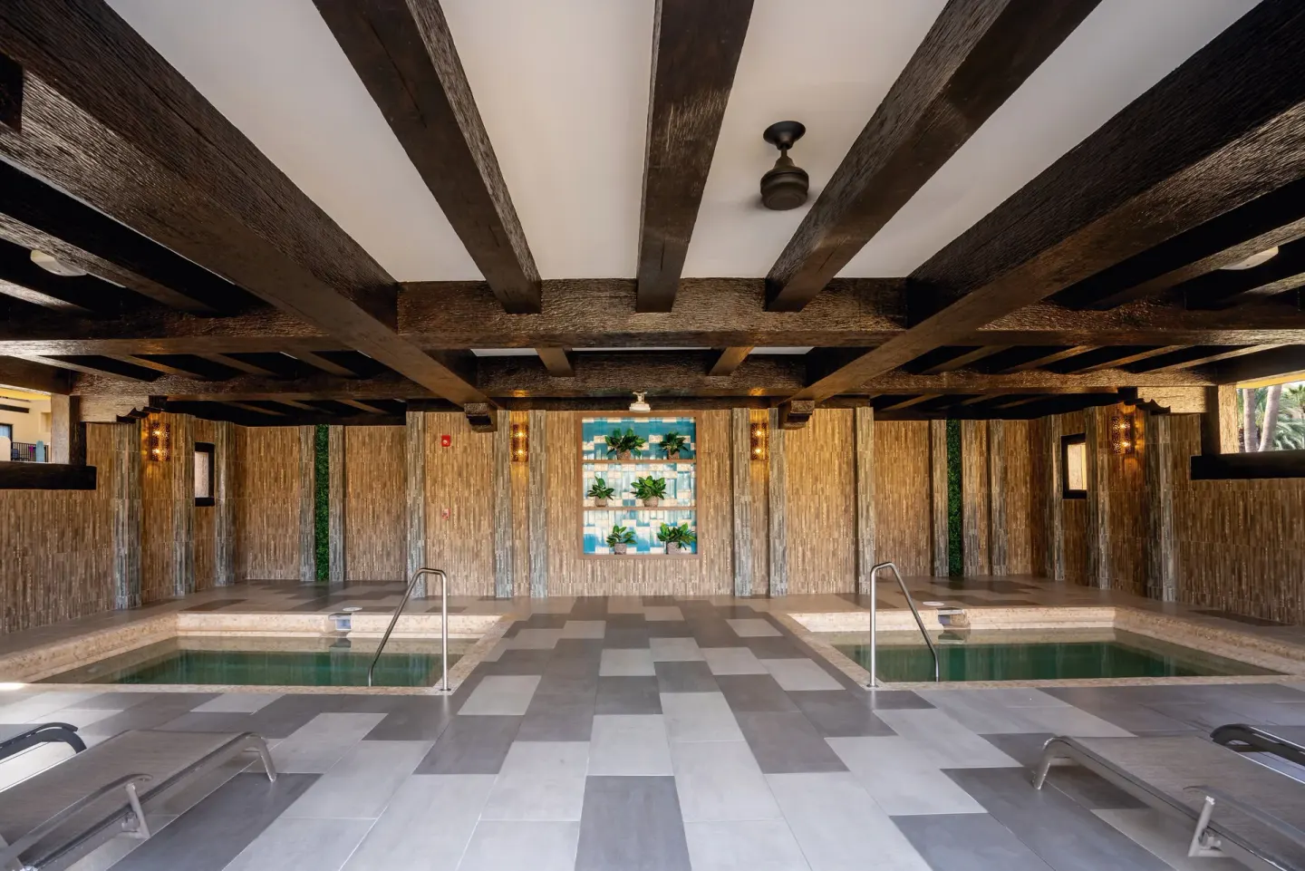 Twin indoor spa pools flank a tiled walkway at Hotel Riu Santa Fe.