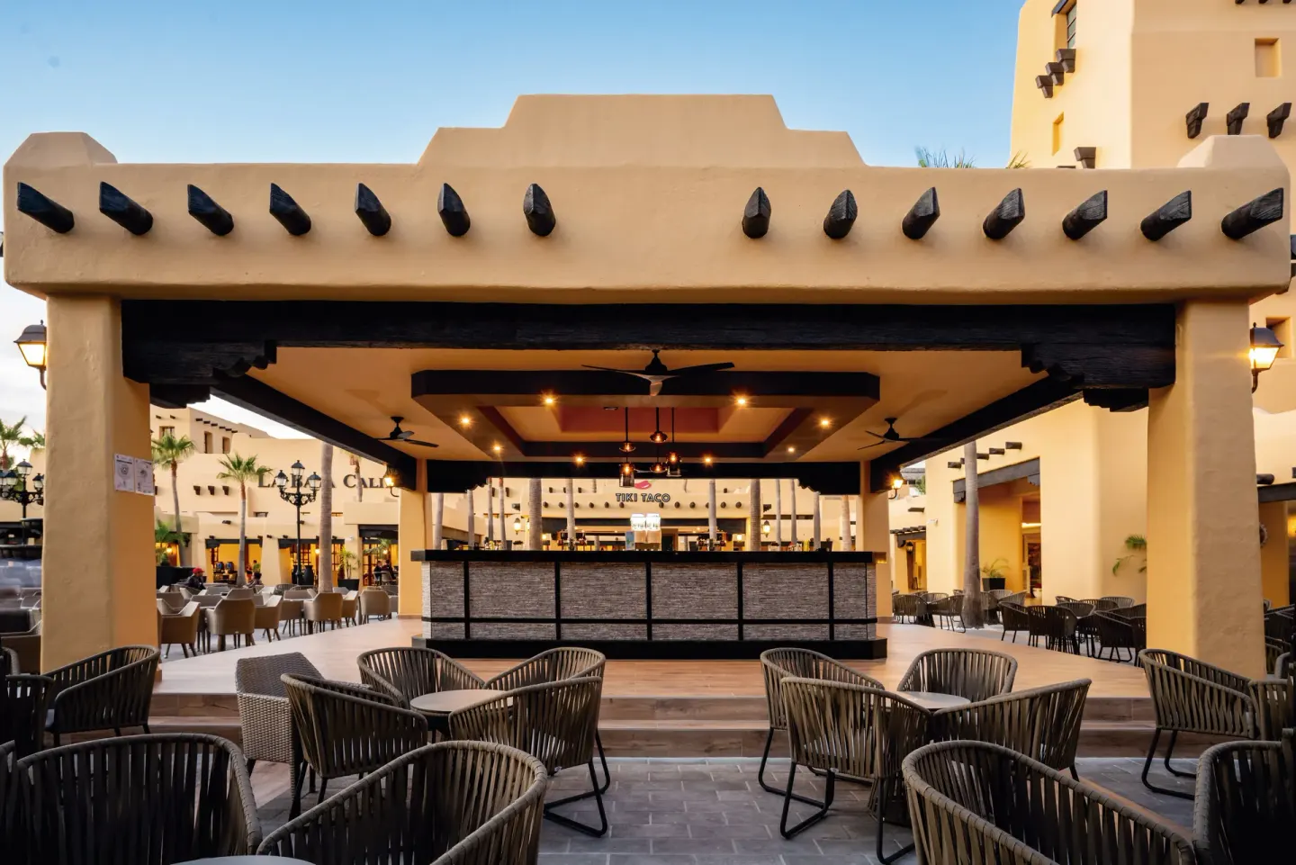Open-air bar pavilion with terrace seating at Hotel Riu Santa Fe.