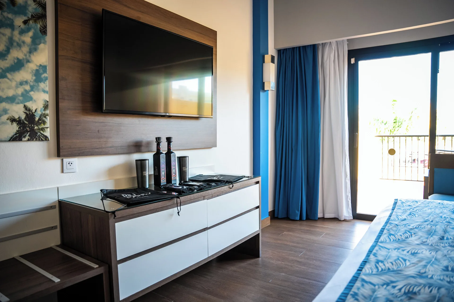 Hotel Riu Santa Fe at Hotel Riu Santa Fe with TV, dresser, balcony doors and party accessories.