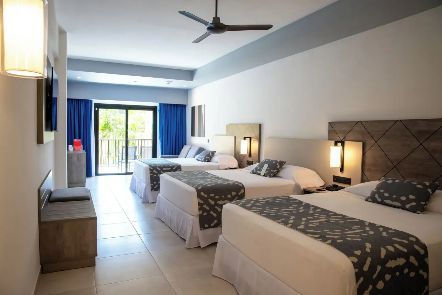 Friends and Family room with three beds and balcony at Hotel Riu Santa Fe.