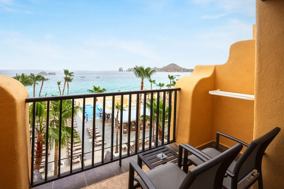 Ocean view balcony with chairs overlooking the beach at Hotel Riu Santa Fe.