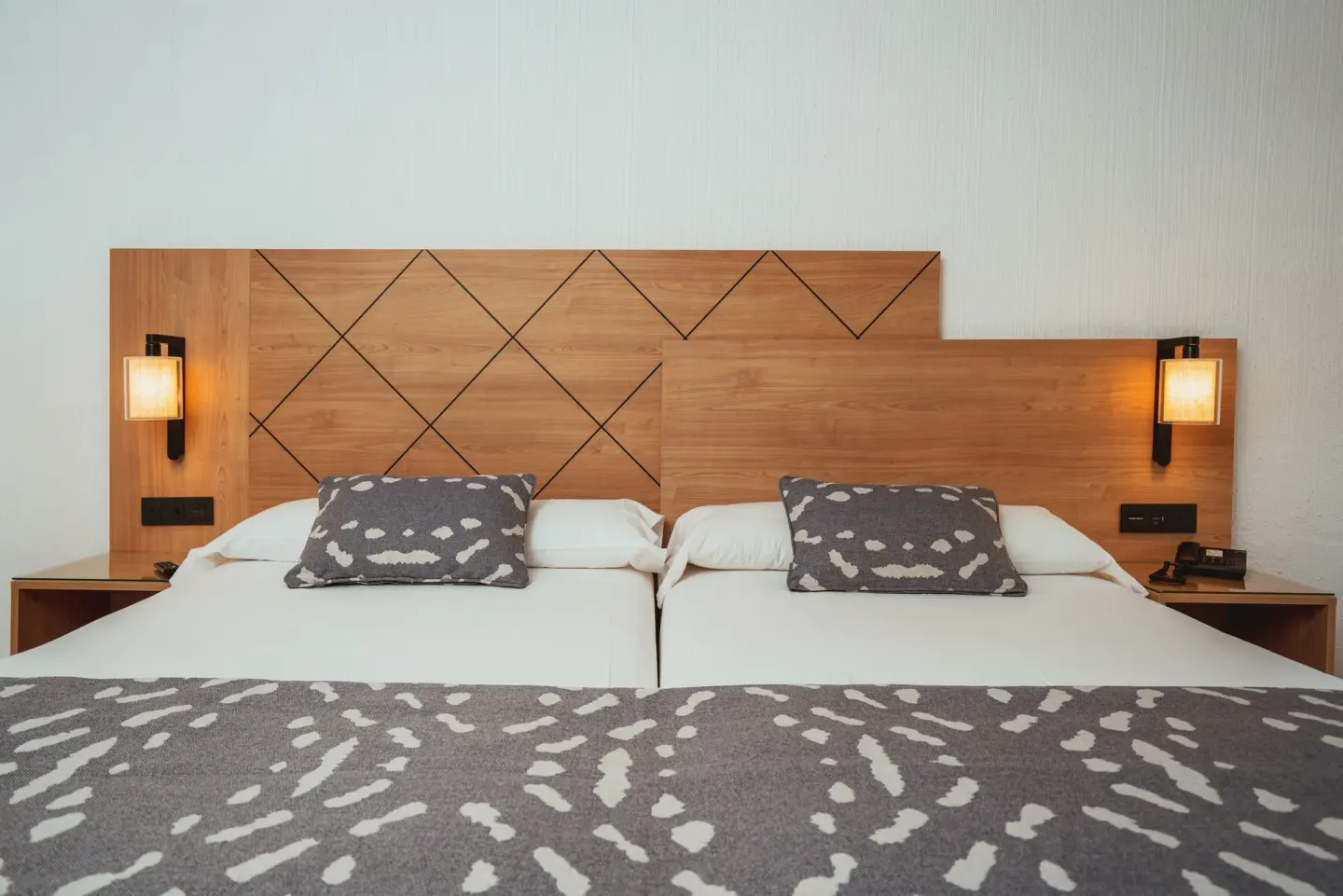 Twin beds with wood headboard in a Partial Ocean View room at Hotel Riu Santa Fe.