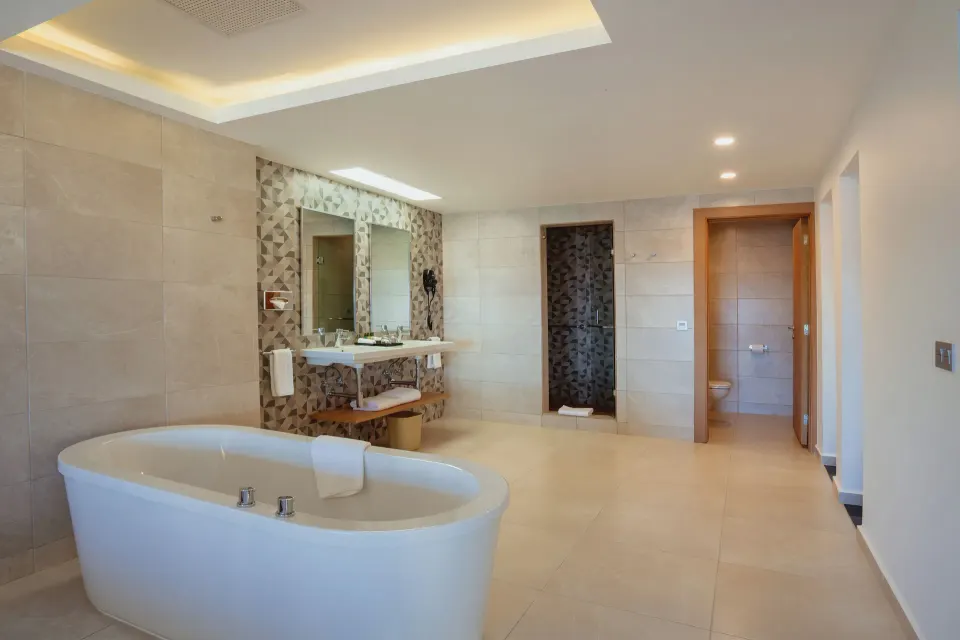 Suite Ocean View bathroom with freestanding tub and shower at Hotel Riu Santa Fe.