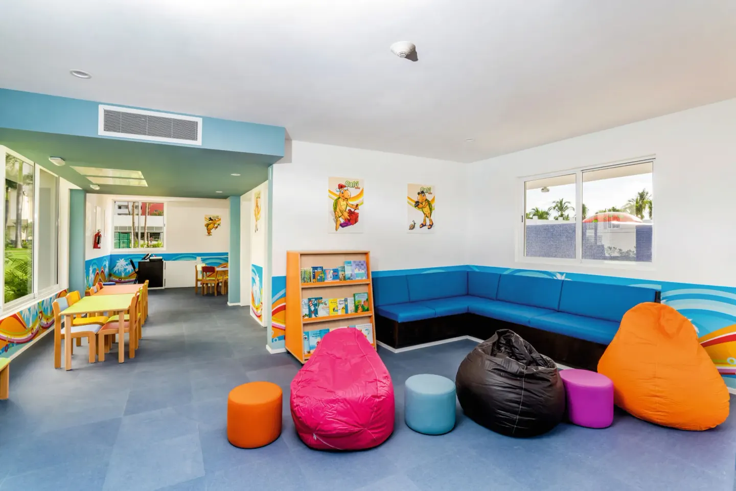 Colorful kids' club lounge with beanbags and books at Hotel Riu Vallarta.