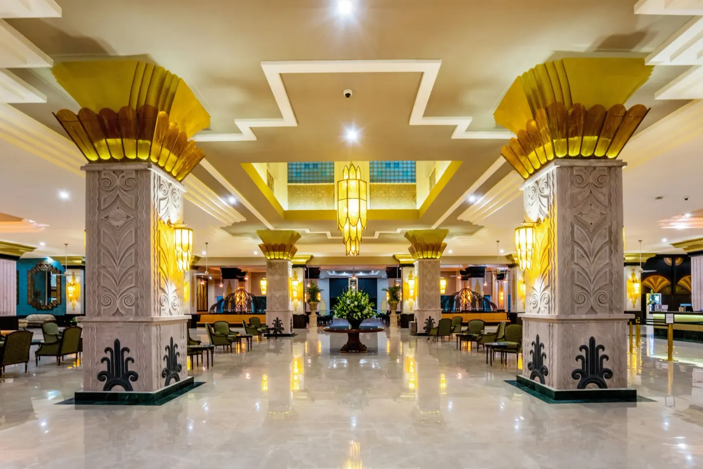 Spacious lobby with ornate columns and lounge seating at Hotel Riu Vallarta.