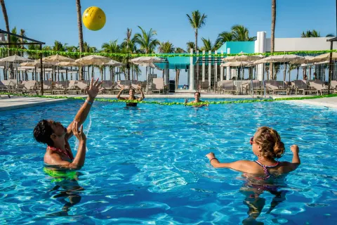 Guests playing pool volleyball in the water at Hotel Riu Vallarta.