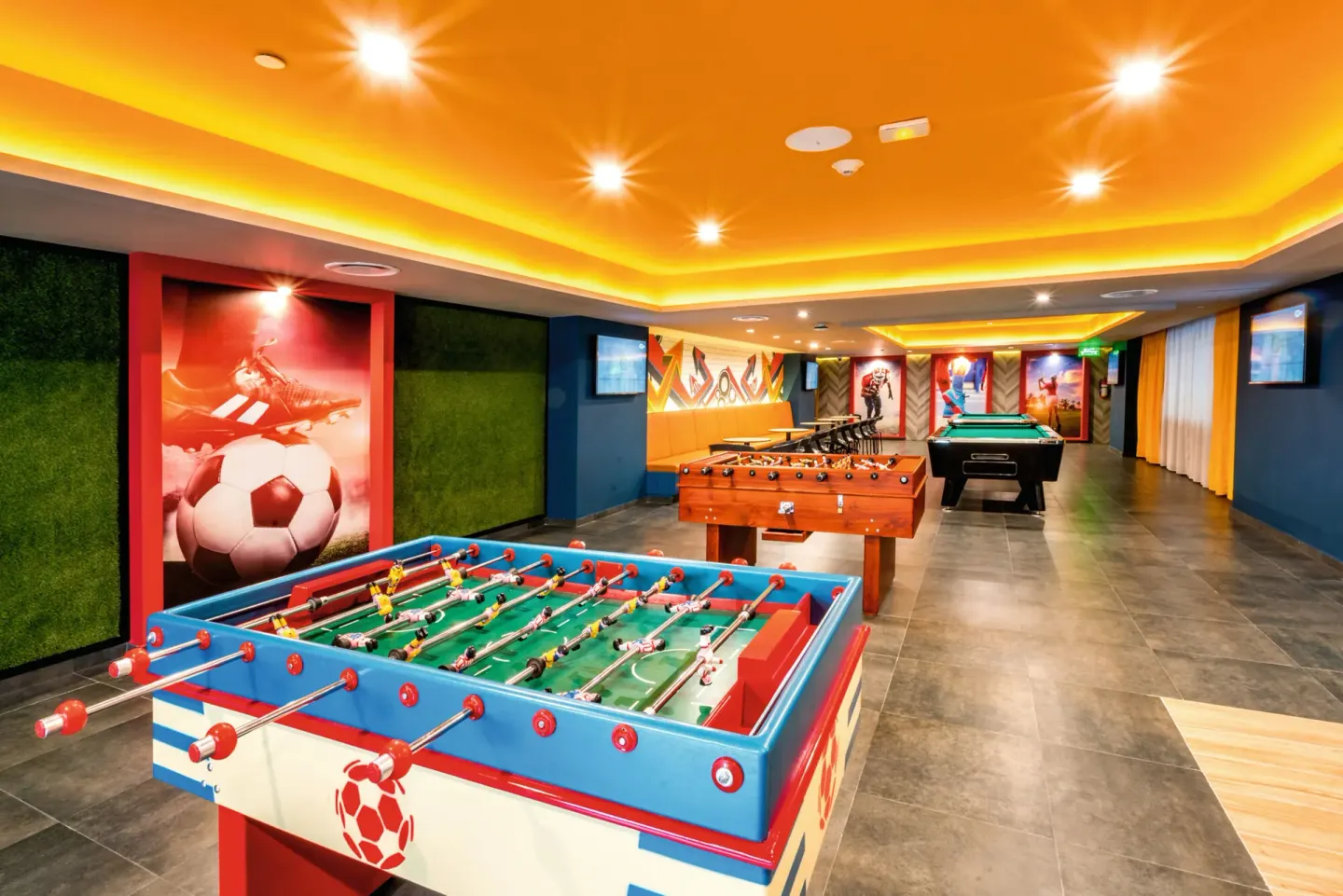 Sports game room with foosball, billiards and soccer art at Hotel Riu Vallarta.