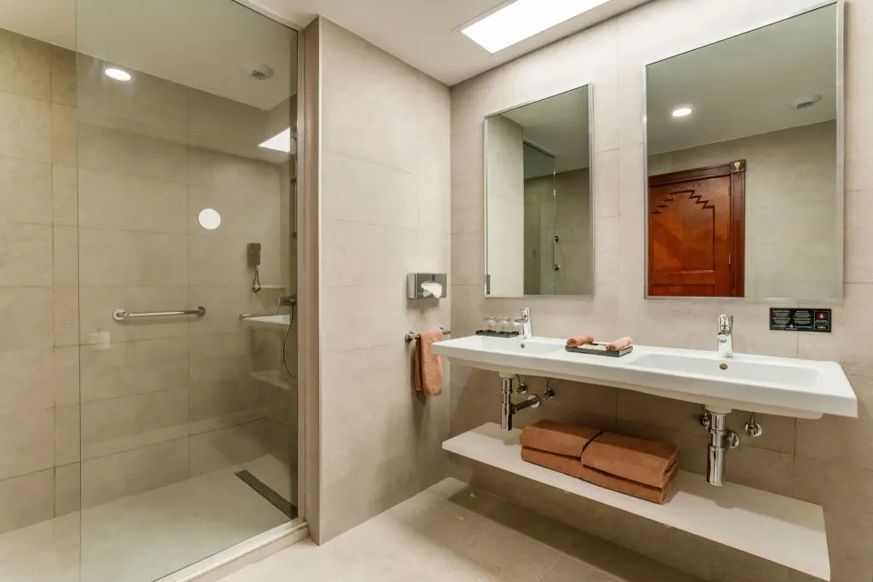 Junior Suite Ocean View bathroom with double sink and shower at Hotel Riu Vallarta.