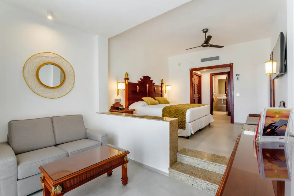 Junior Suite Ocean View sitting area and raised bed at Hotel Riu Vallarta.