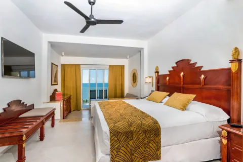 Ocean View Junior Suite with king bed and balcony at Hotel Riu Vallarta.
