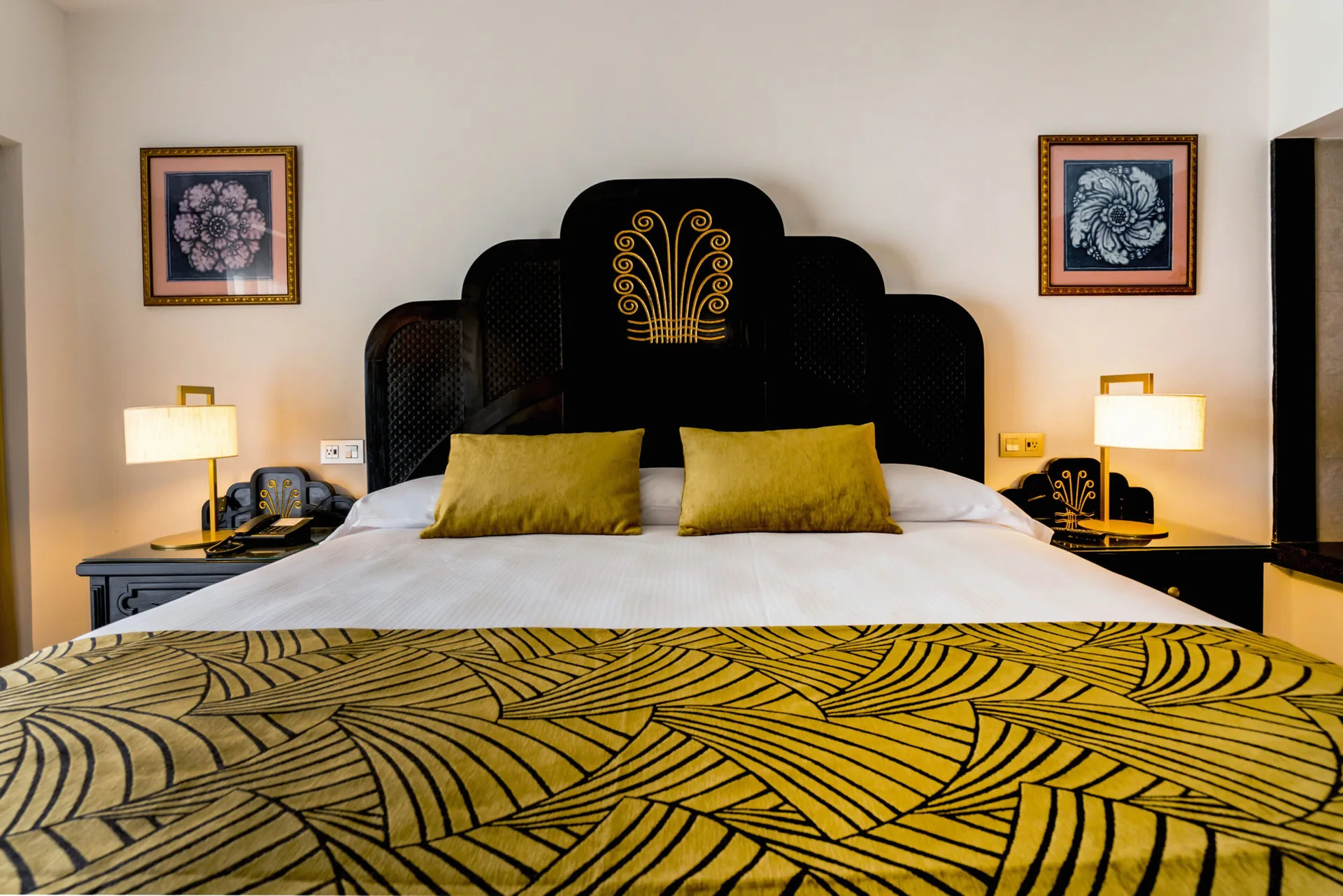 Suite Ocean View king bed with black headboard and gold accents at Hotel Riu Vallarta.