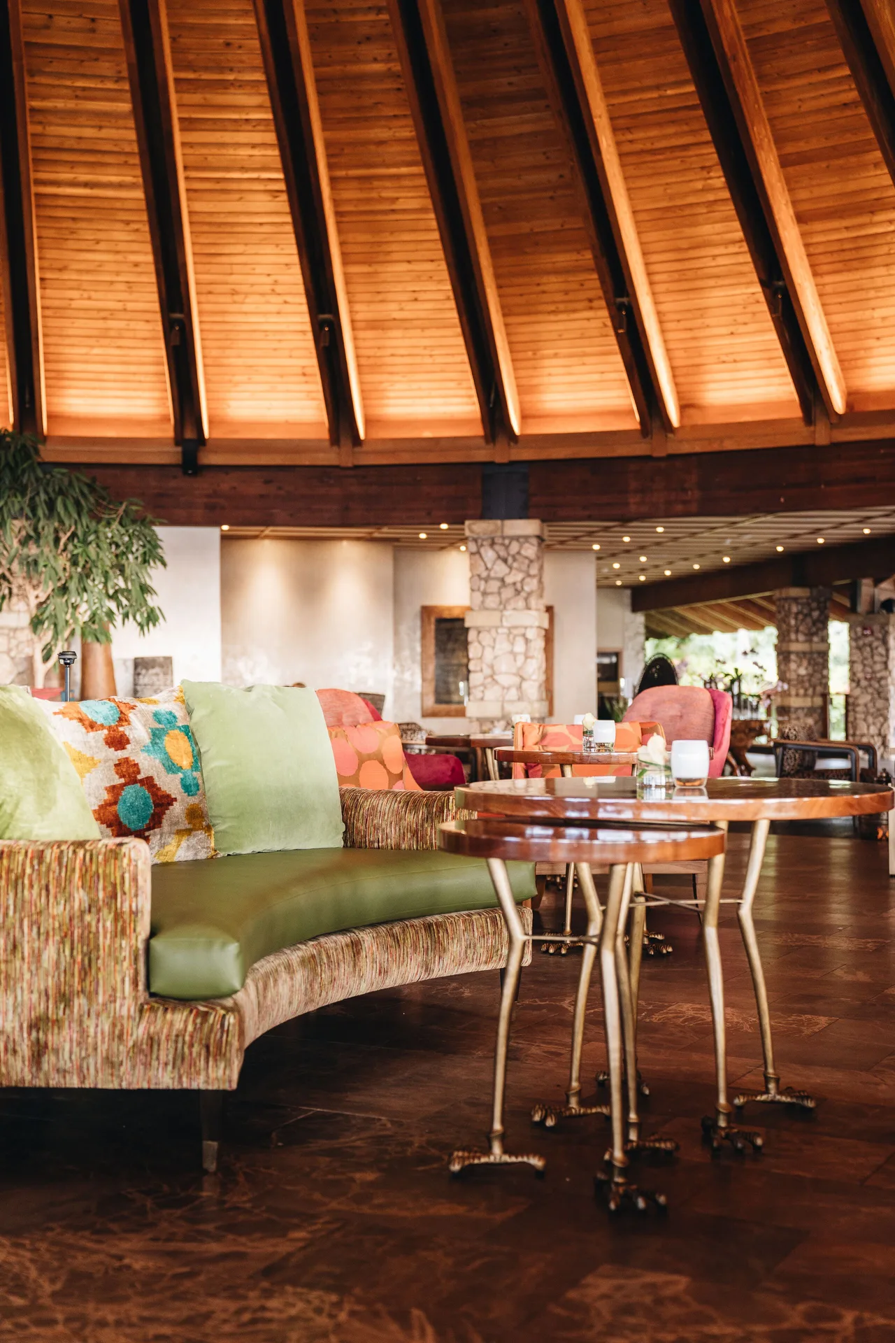 Colorful lounge seating sits beneath a warm wood ceiling at Hotel Wailea.
