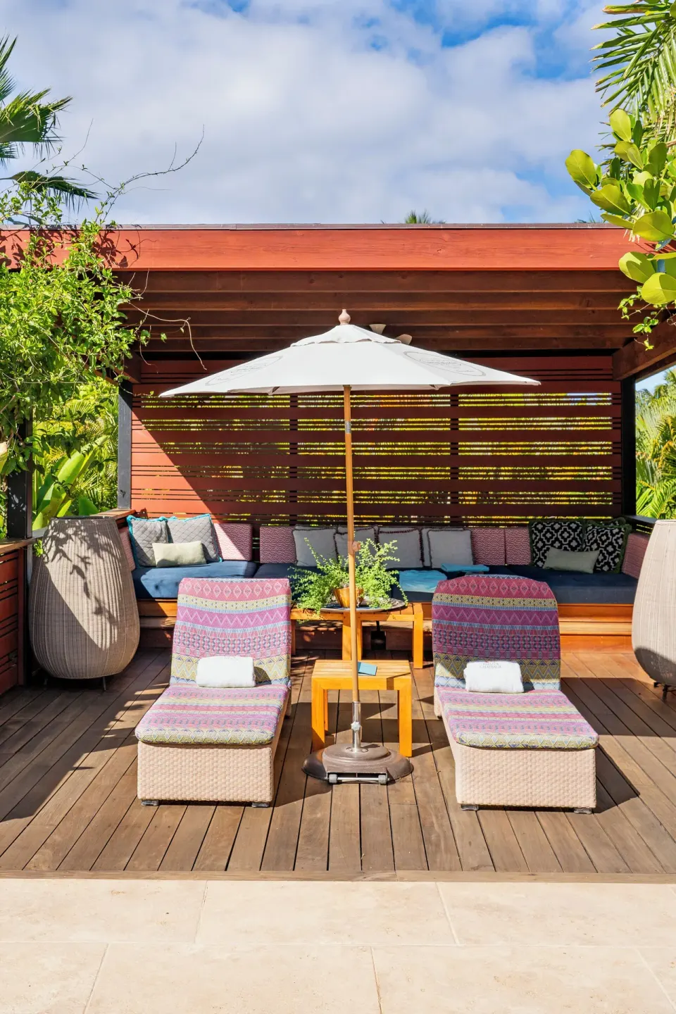 Pool cabana with umbrella, two cushioned loungers, and built-in seating at Hotel Wailea.
