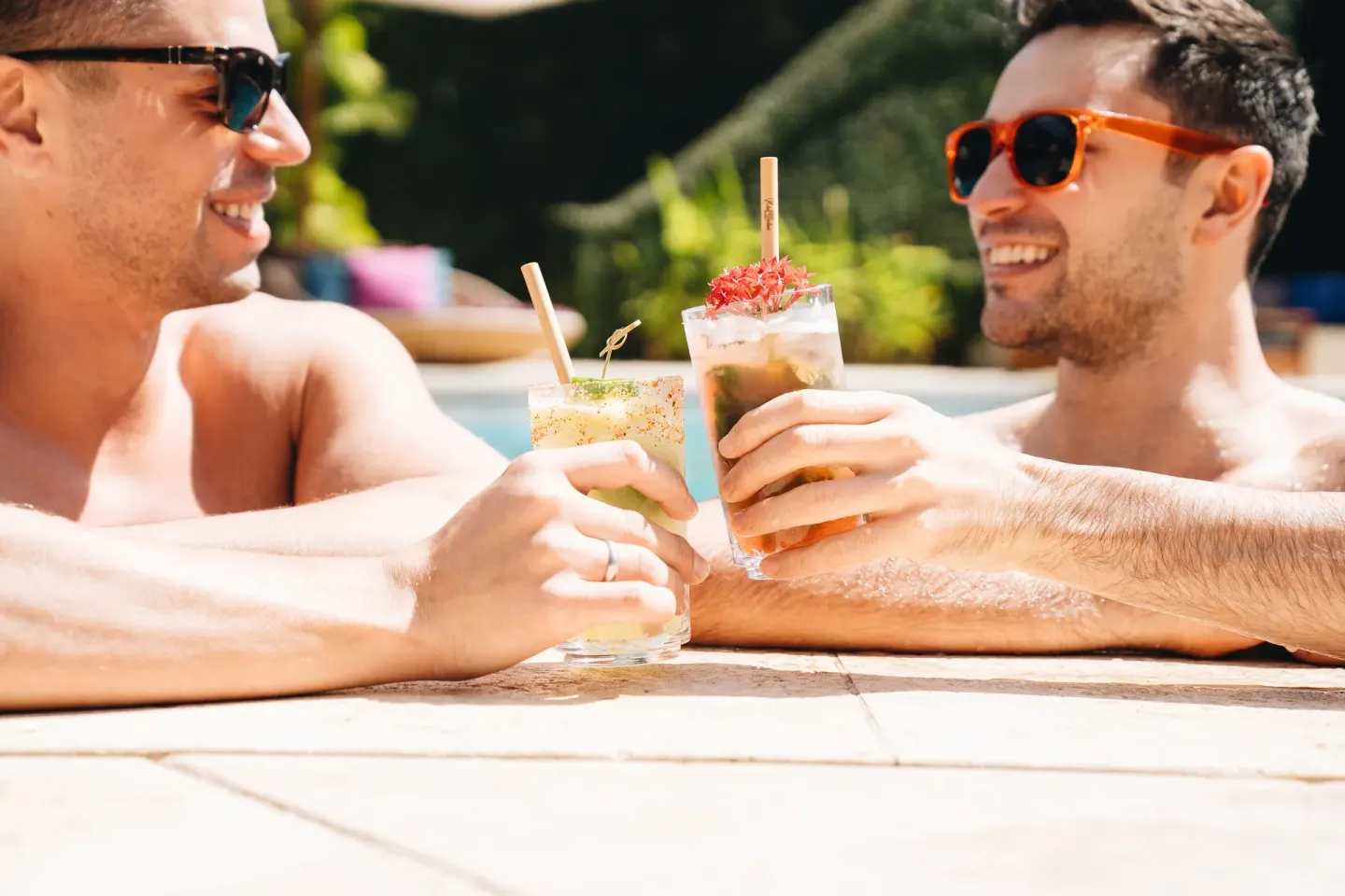 Two guests toast cocktails in the pool at Hotel Wailea.