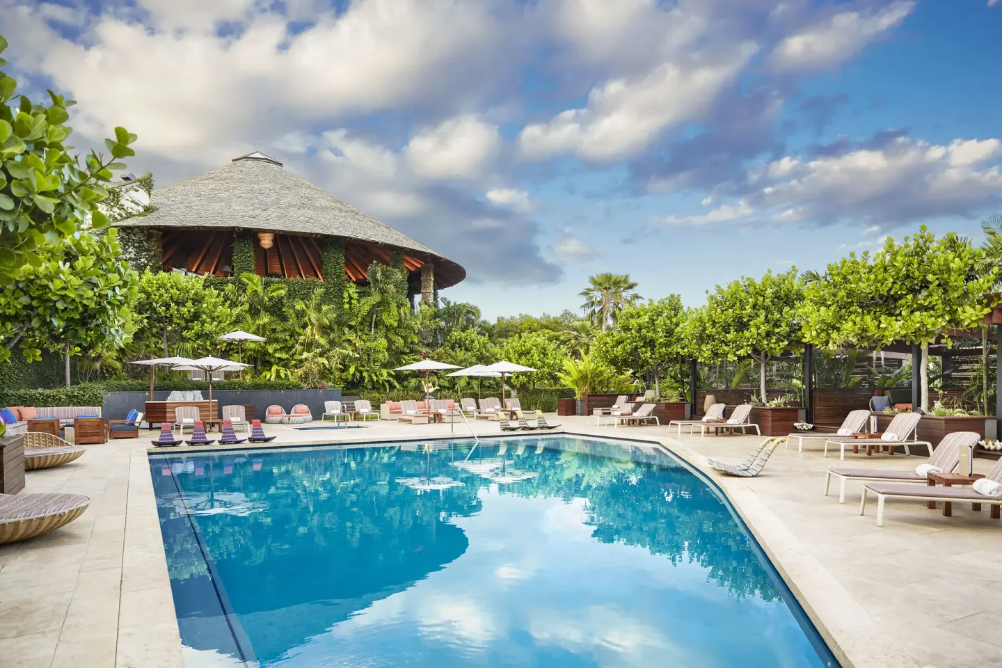 Resort pool with loungers, umbrellas, cabanas, and pavilion at Hotel Wailea.
