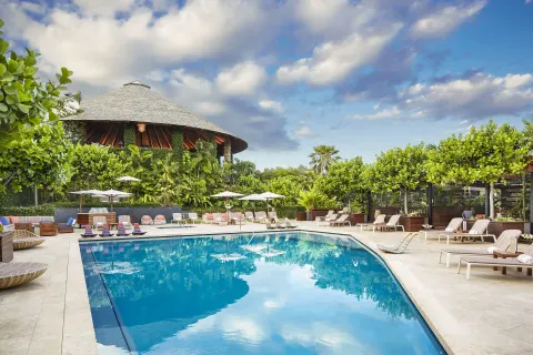 Resort pool with loungers, umbrellas, cabanas, and pavilion at Hotel Wailea.