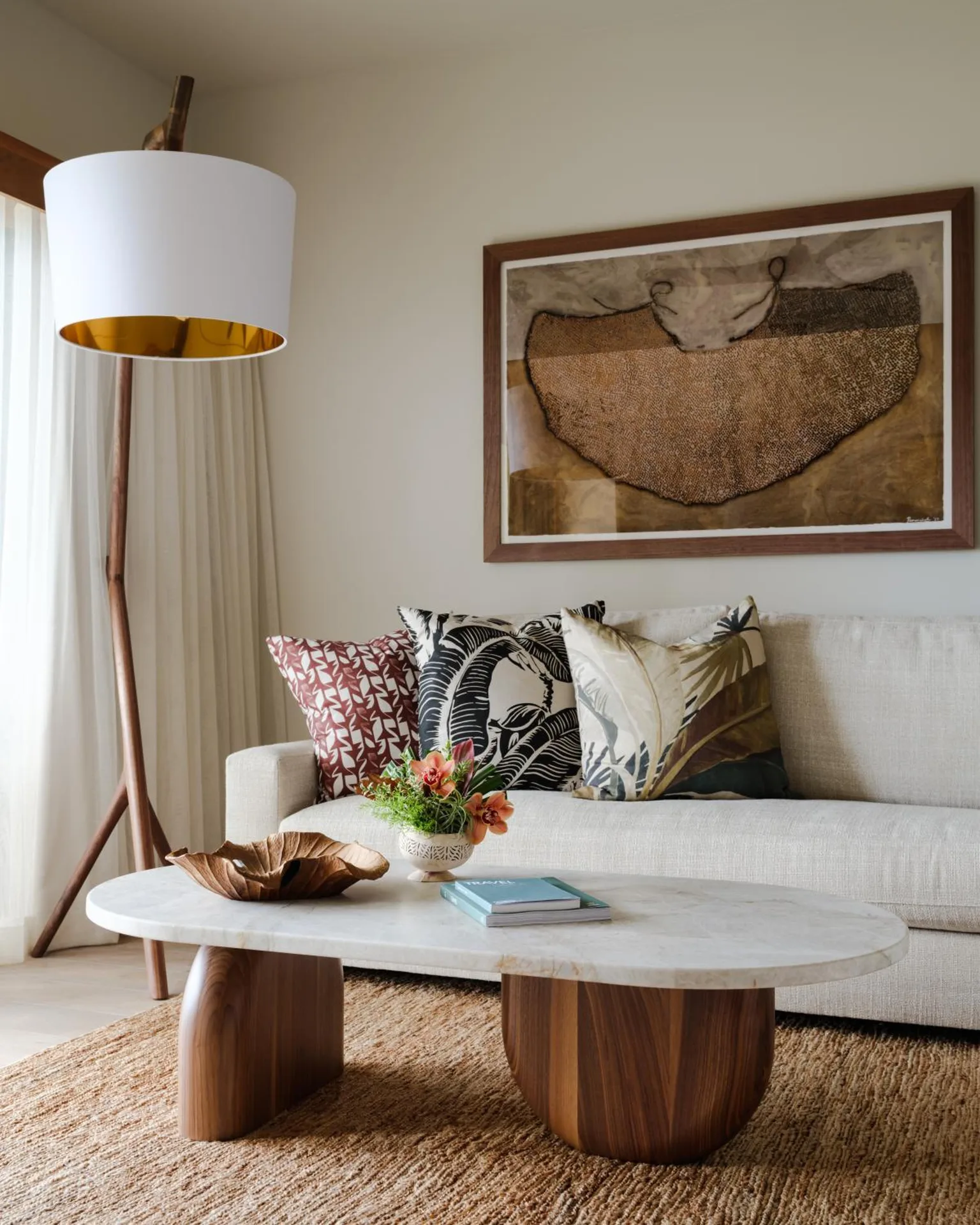 Garden View One Bedroom Suite sofa seating with art and marble table at Hotel Wailea.