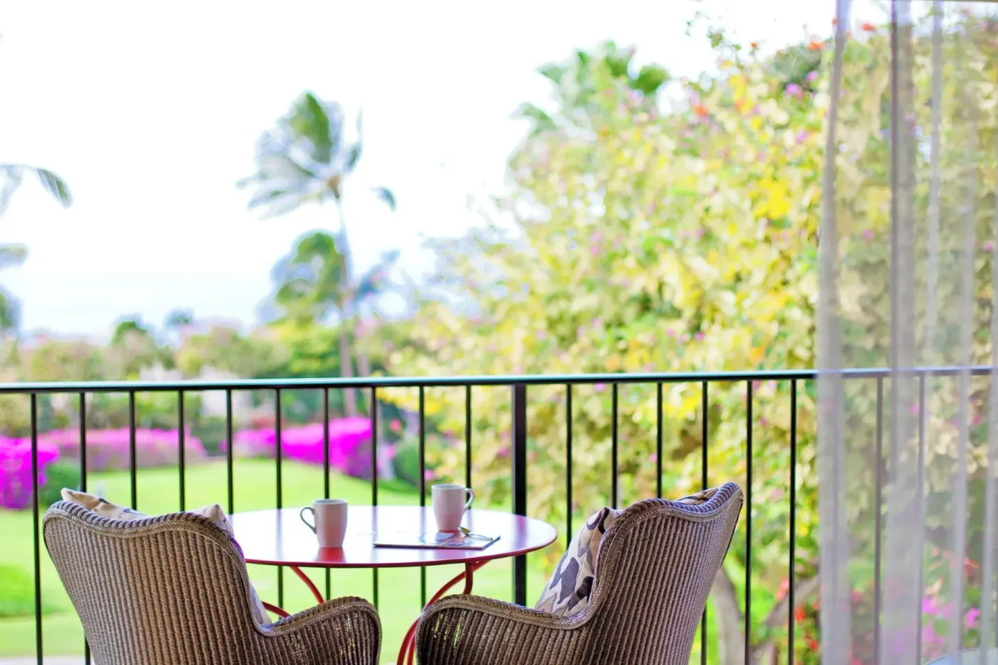 Partial Ocean View Suite lanai with chairs and garden view at Hotel Wailea.