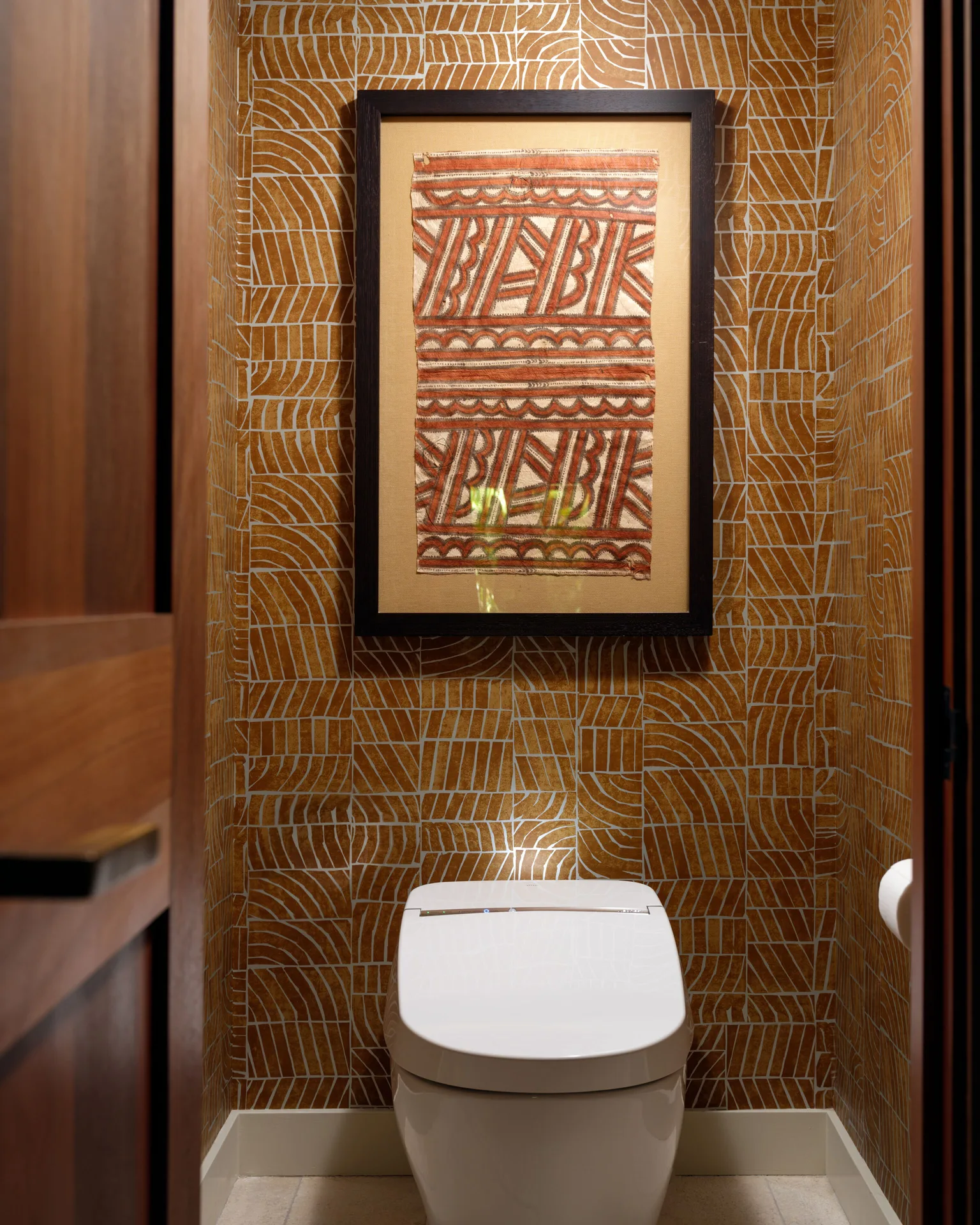 Ocean View Suite powder room with patterned wall and framed artwork at Hotel Wailea.