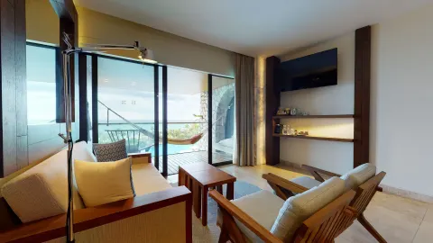 Junior Suite Ocean View living area with balcony and hammock at Hotel Xcaret Arte.