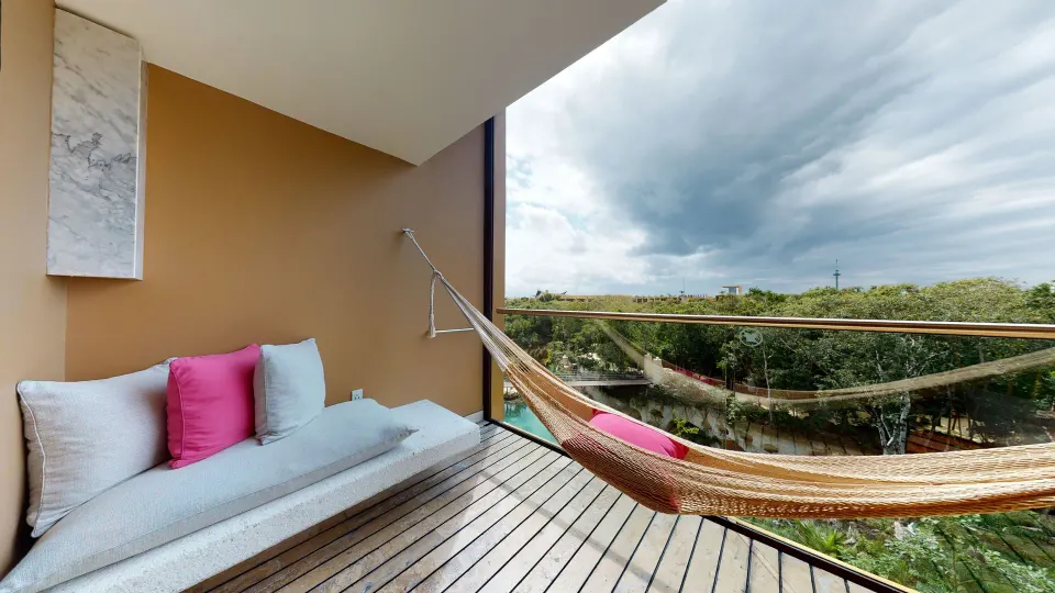Junior Suite river spa balcony with hammock and daybed at Hotel Xcaret Arte.