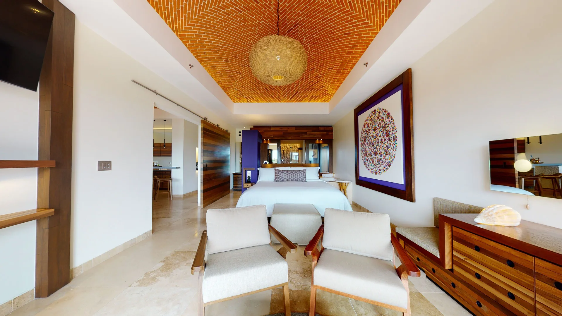 Junior Suite river spa bedroom with seating area at Hotel Xcaret Arte.