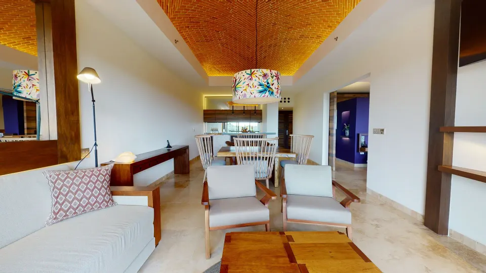 Junior Suite river spa living area with seating and dining at Hotel Xcaret Arte.