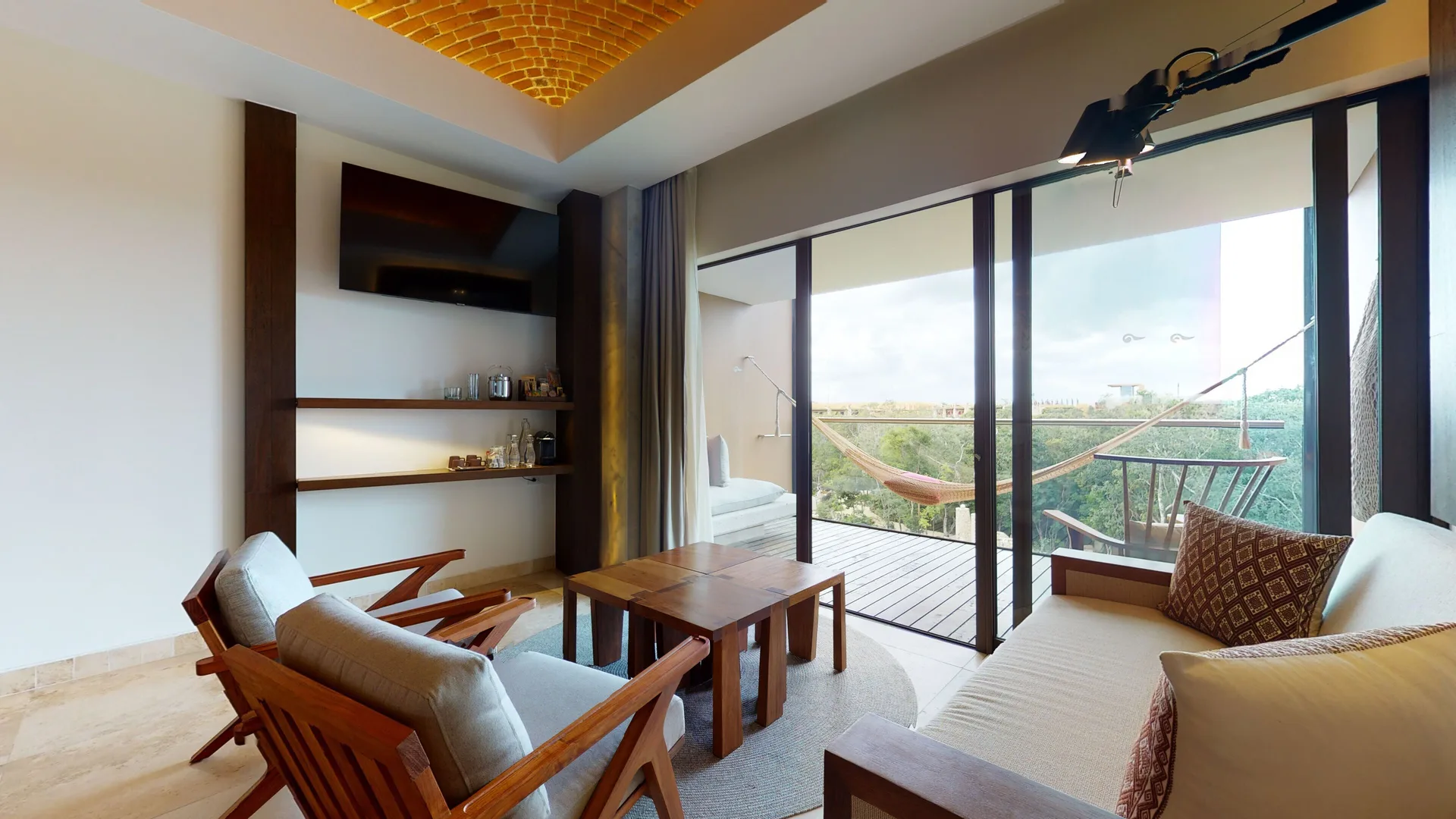 Junior Suite river spa sitting area and balcony hammock at Hotel Xcaret Arte.