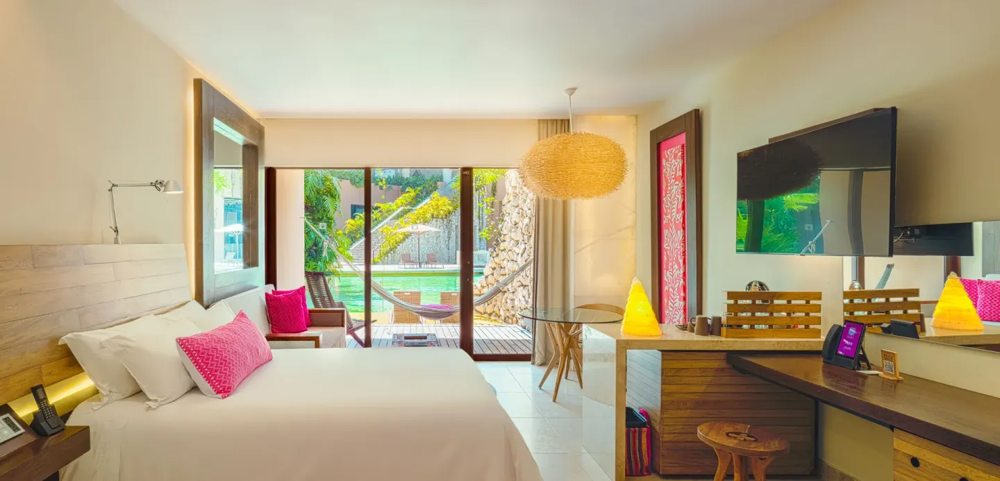 Garden Swim Up room with king bed and terrace hammock at Hotel Xcaret Arte.