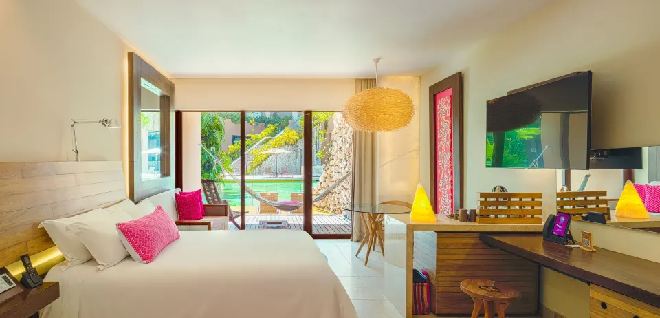 Garden Swim Up room with king bed and terrace hammock at Hotel Xcaret Arte.