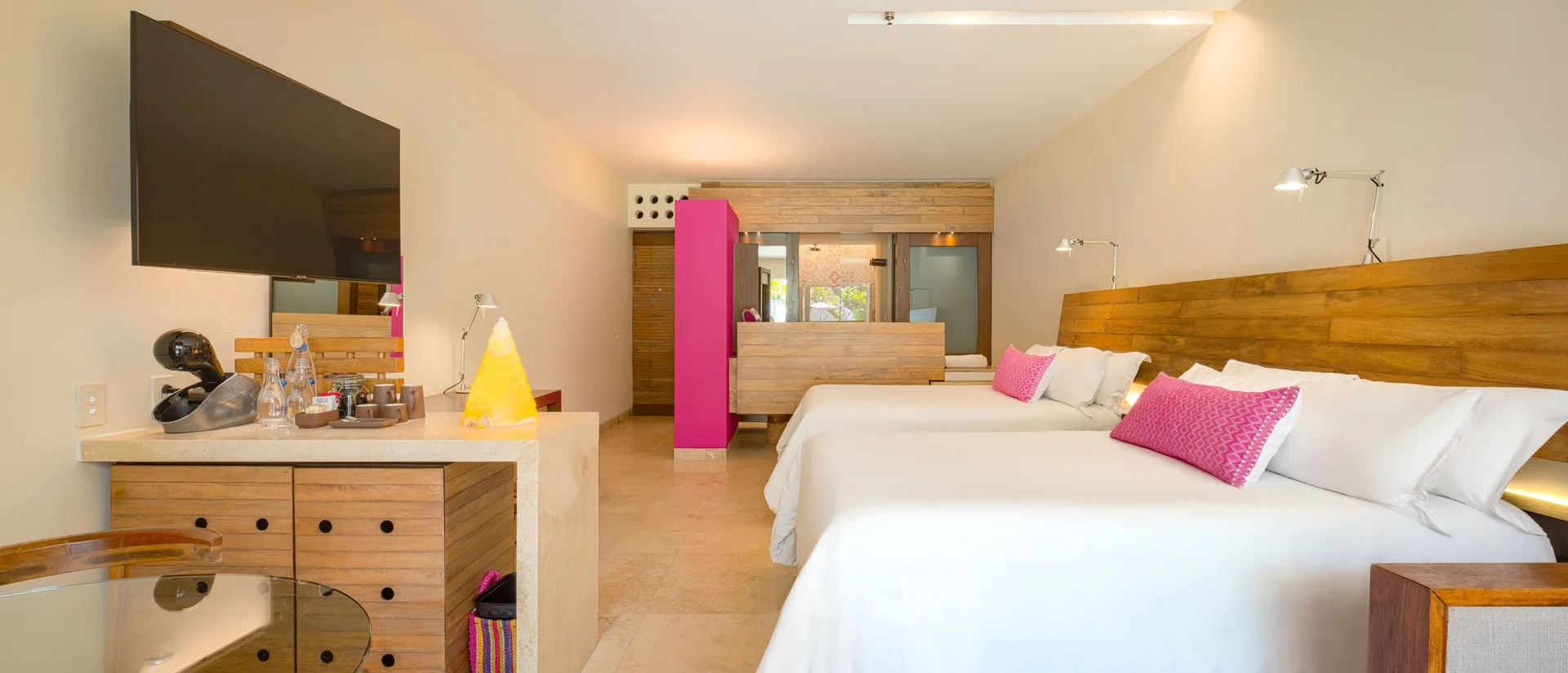 Garden Swim Up room with king bed, TV, and open vanity area at Hotel Xcaret Arte.