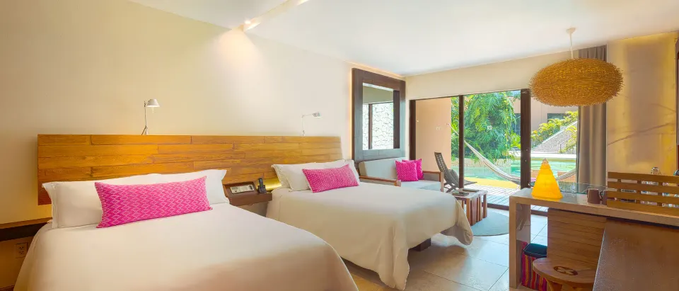 Garden Swim Up room with two beds and terrace view at Hotel Xcaret Arte.