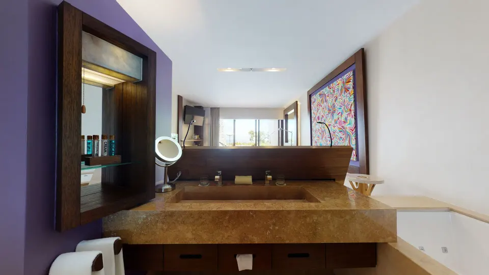 Bathroom vanity and tub in an Oceanfront Swim Up room at Hotel Xcaret Arte.