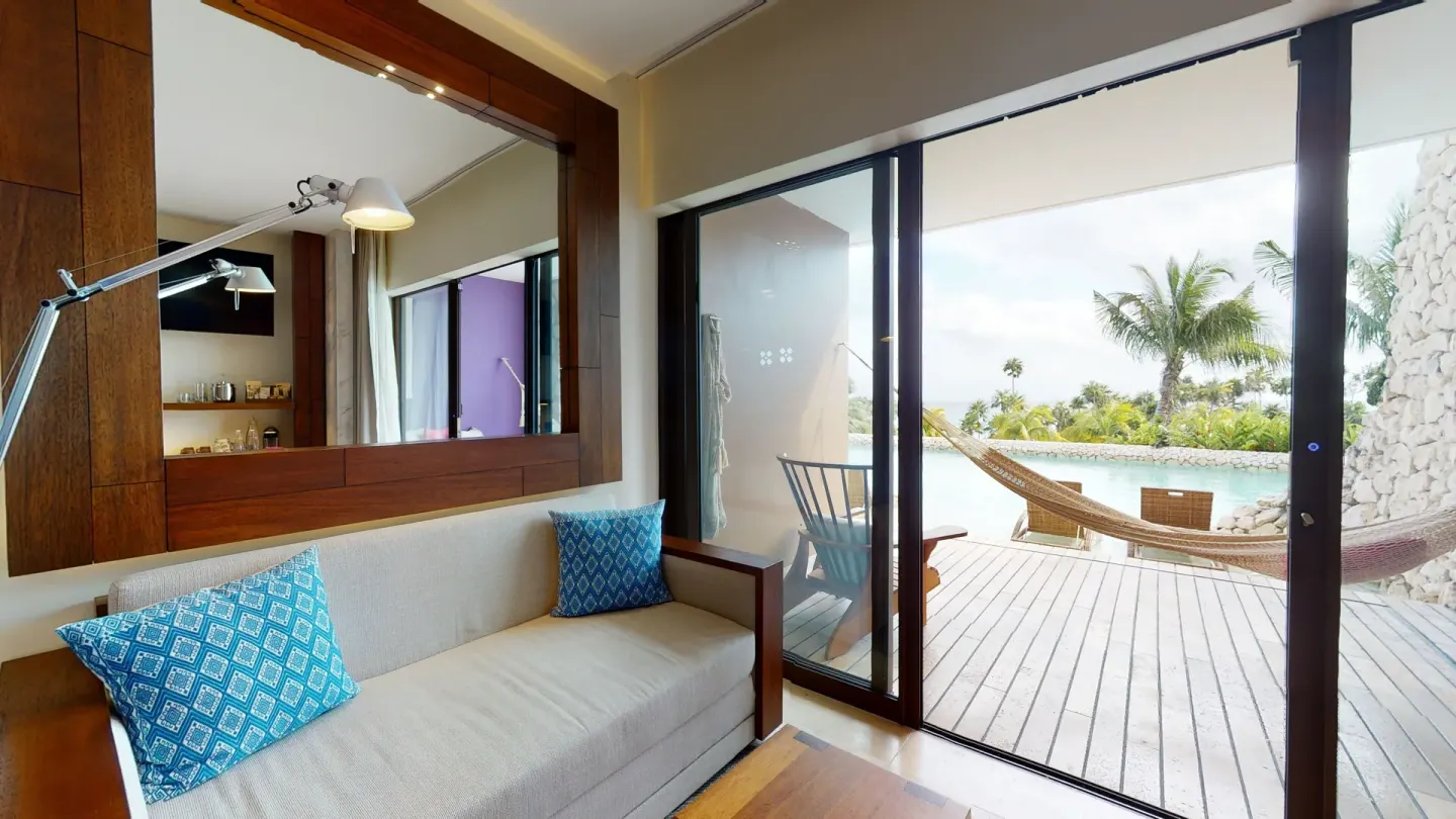 Oceanfront room sitting area and terrace with hammock at Hotel Xcaret Arte.