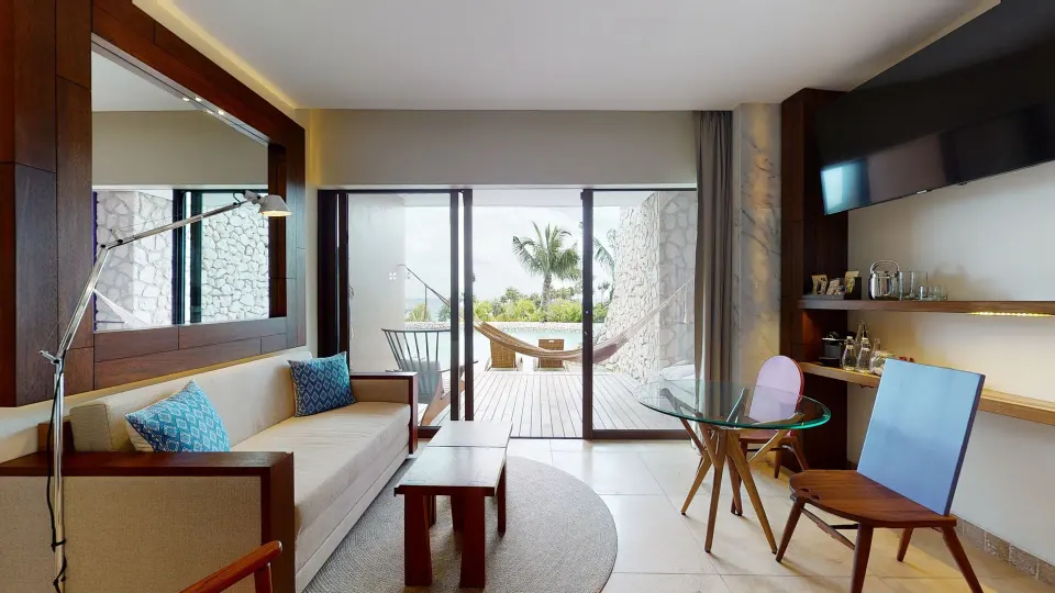 Oceanfront room lounge area with terrace view at Hotel Xcaret Arte.