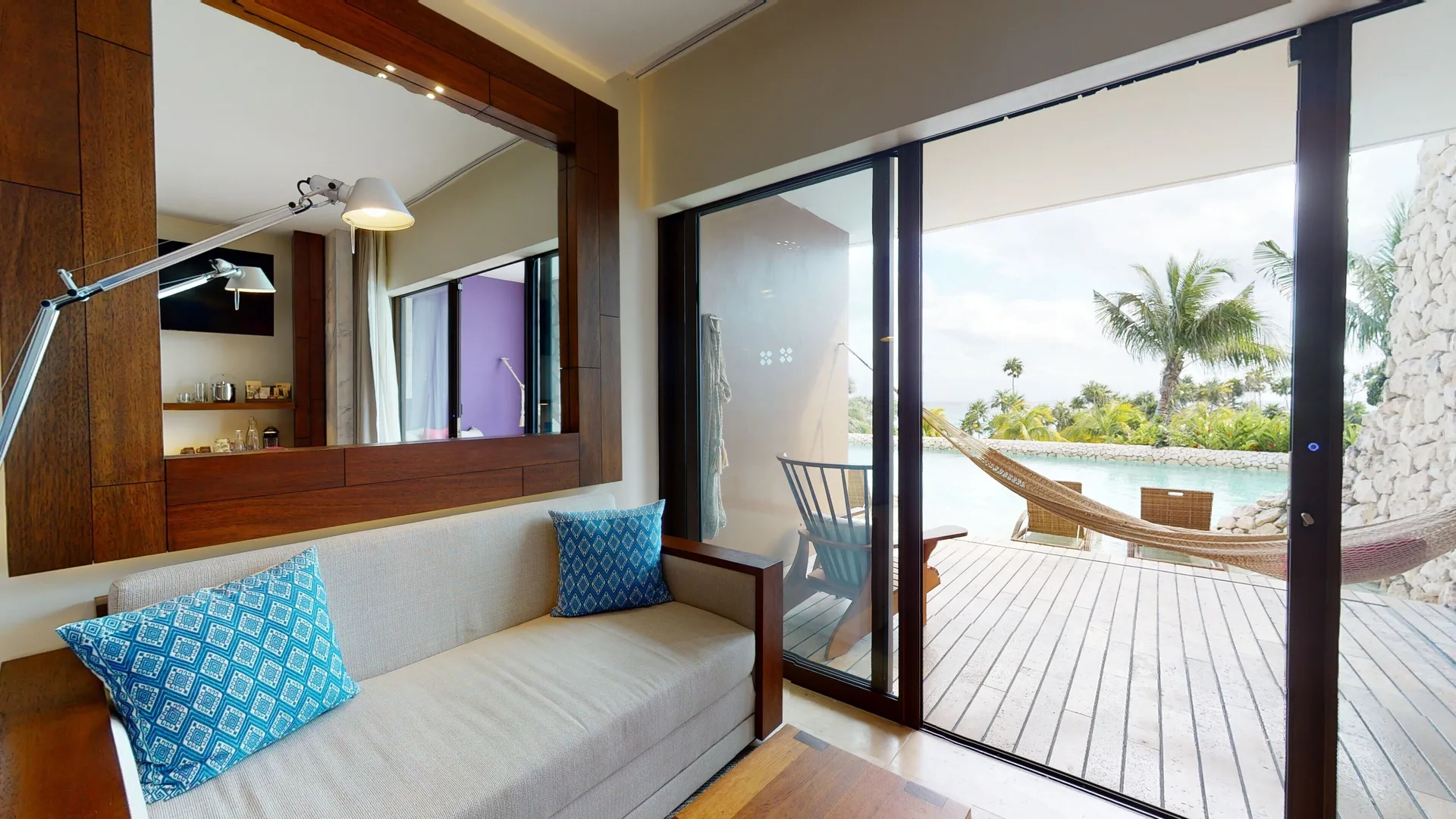 Oceanfront room sitting area and terrace hammock at Hotel Xcaret Arte.