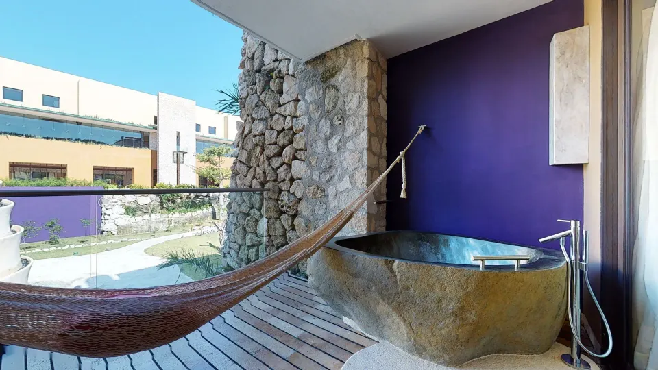 Suite Garden Spa balcony with hammock and soaking tub at Hotel Xcaret Arte.