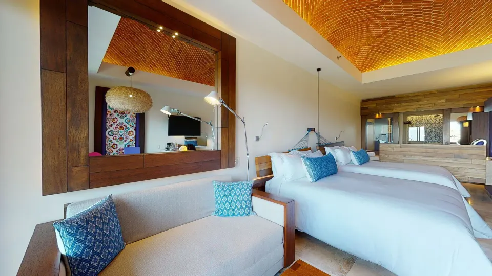 Suite Garden room with two beds and sofa at Hotel Xcaret Arte.